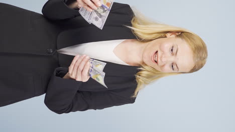 Vertical-video-of-Business-woman-counting-money-looking-at-camera.